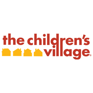 Logo for The Children’s Village, featuring the words in red and four yellow house icons forming part of the text—perfect for representing a children’s home or child care organization.